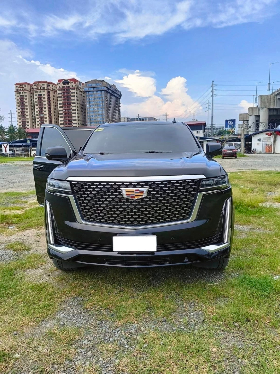 Front view of the black Cadillac Escalade 4x4; license plate area is blank