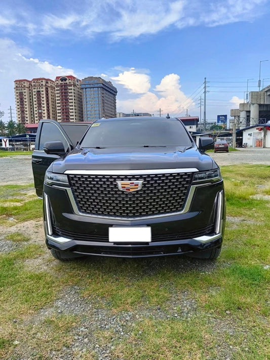 Front view of the black Cadillac Escalade 4x4; license plate area is blank